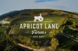 Apricot Lane farms moorpark CA, picture of tractor logo over a portrait of the farm