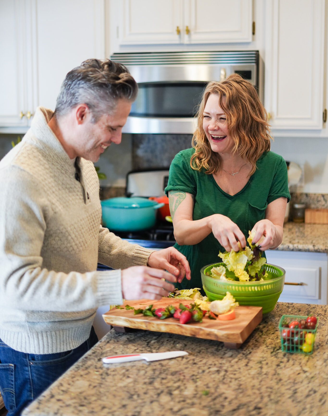 Farm box in the kitchen with a happy couple eating healthy 